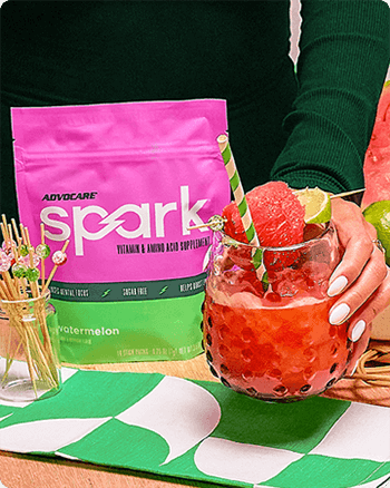 Person holding a Watermelon Lime Frose on a table next to a Spark Watermelon gusset bag.
