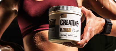 Woman in workout clothes holding a Creatine+ canister.