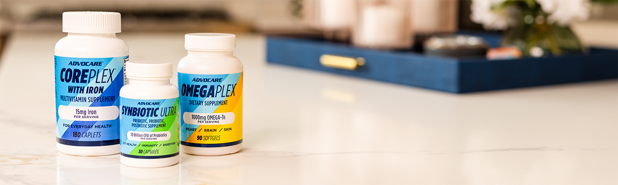 AdvoCare CorePlex with Iron, Synbiotic Ultra, and OmegaPlex bottles on a kitchen counter.