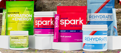 AdvoCare Spark, Rehydrate and Hydration + Energy products sitting on stadium seating.