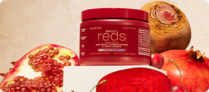 AdvoCare Daily Reds canister surrounded by sliced pomegranates and beet roots.
