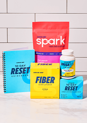 AdvoCare 10-Day Reset bundle products in front of a white tiled wall.